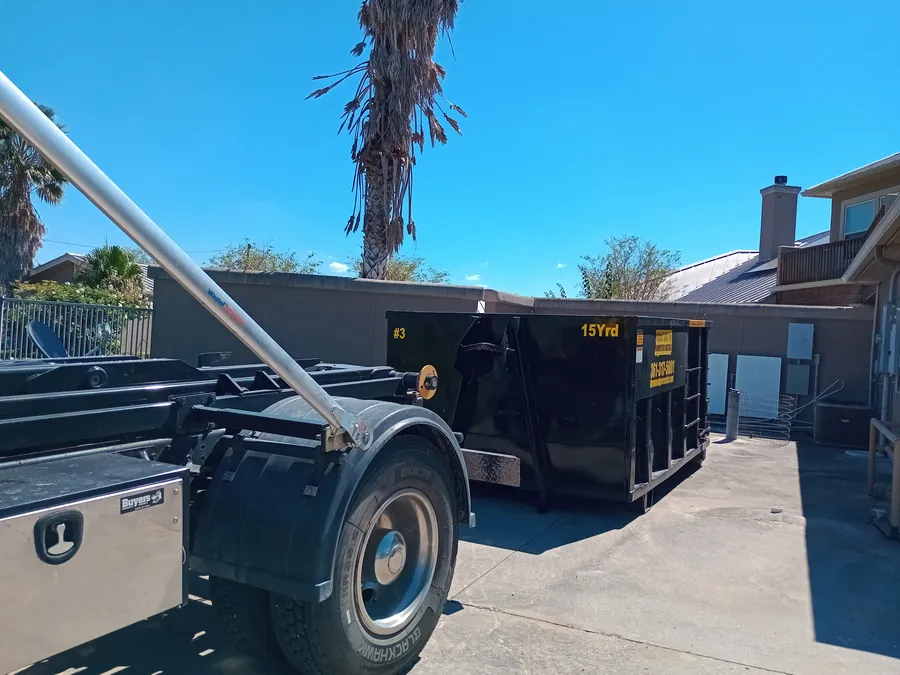 Roll-off dumpster sitting in a Corpus Christi neighborhood during a multi-day project
